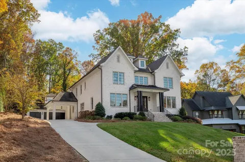 a front view of a house with a garden and yard