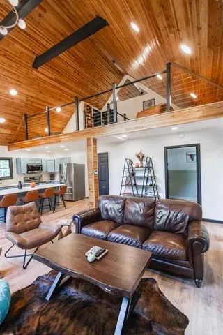 a kitchen with stainless steel appliances granite countertop a refrigerator a stove a sink dishwasher and microwave with wooden floor