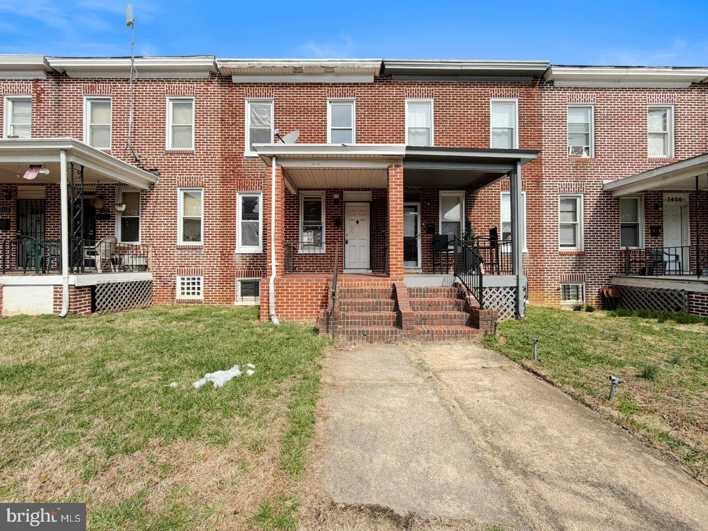 3420 Lyndale Avenue Baltimore, MD 21213 - Photo 1 of 24 front view of a brick house with a yard