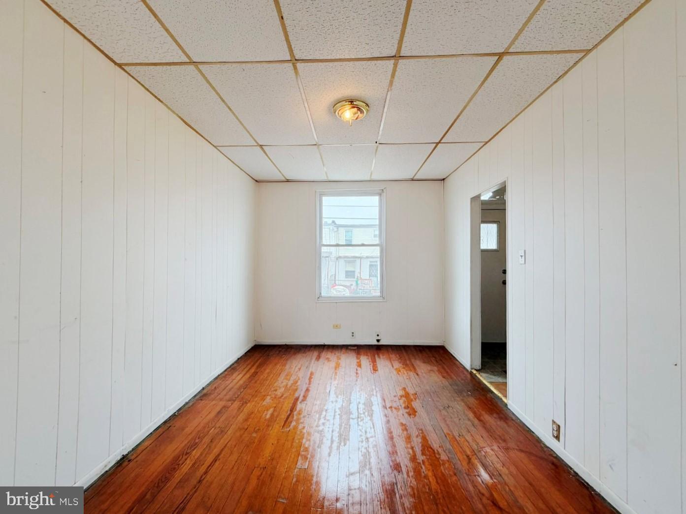 3420 Lyndale Avenue Baltimore, MD 21213 - Photo 7 of 24 a view of a room with wooden floors and white walls