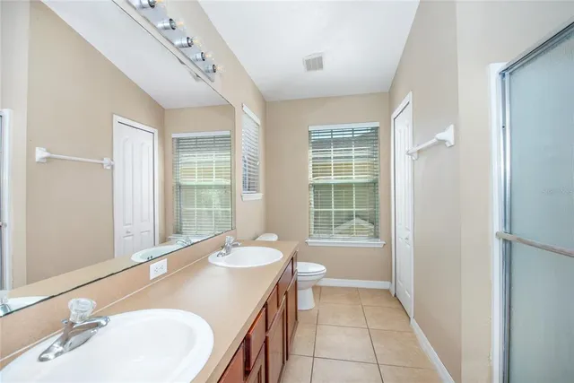 a bathroom with a granite countertop sink a mirror and a bathtub
