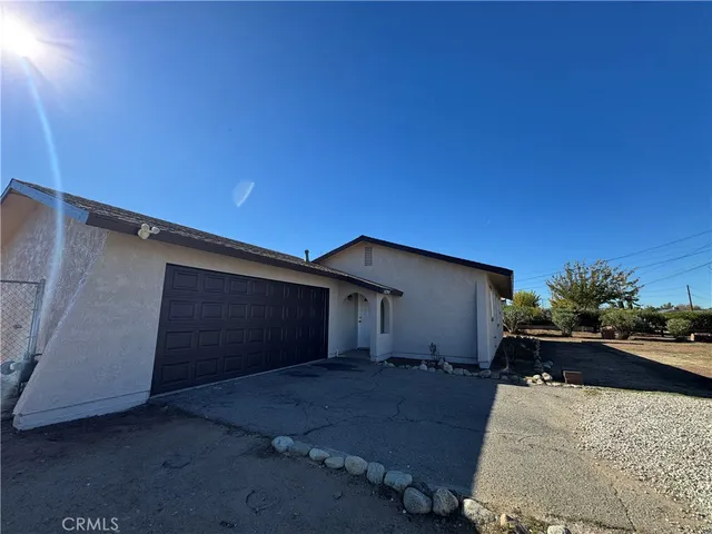 a backyard of a house with garage and yard