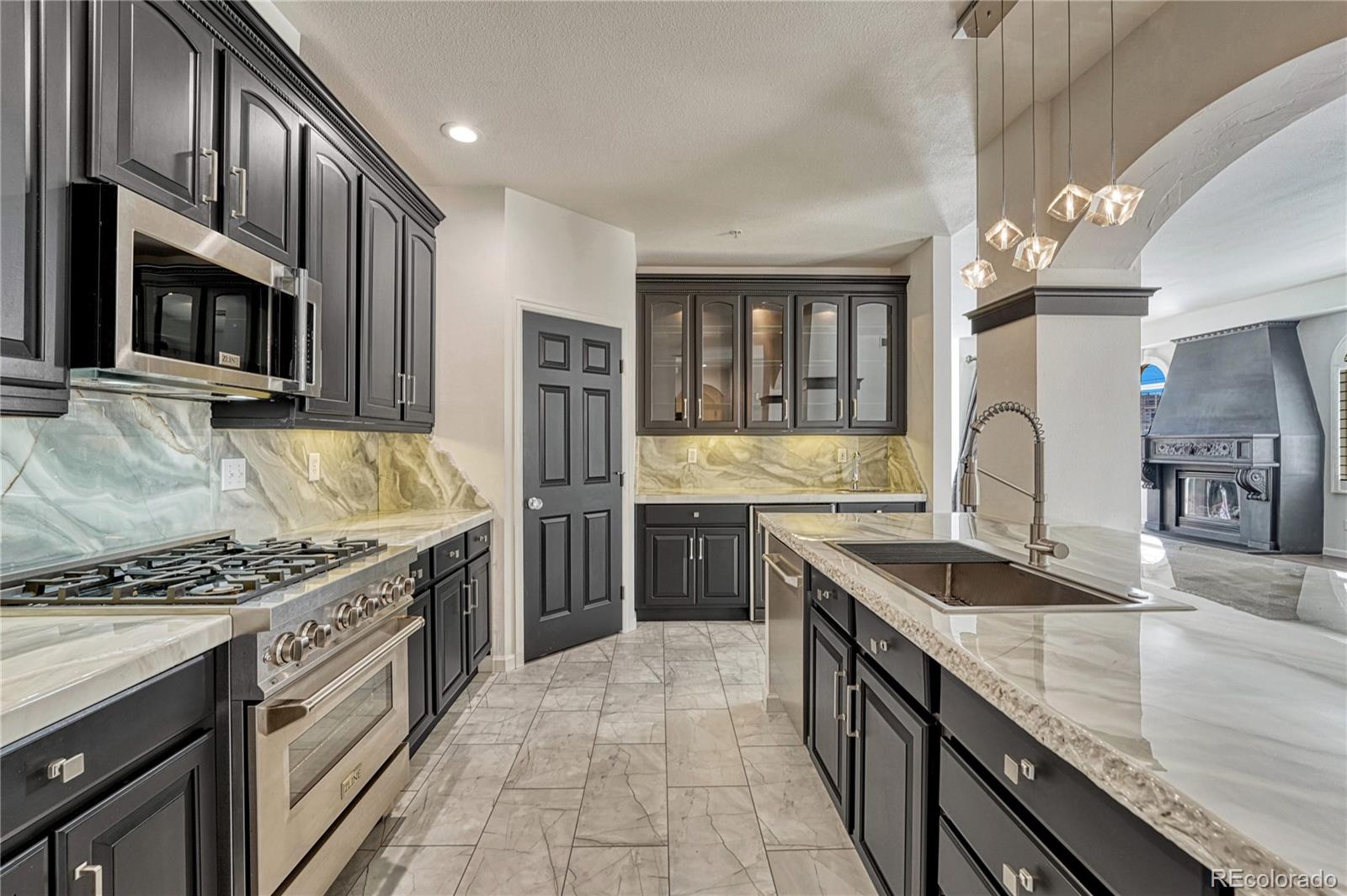 a kitchen with stainless steel appliances granite countertop a sink stove and refrigerator