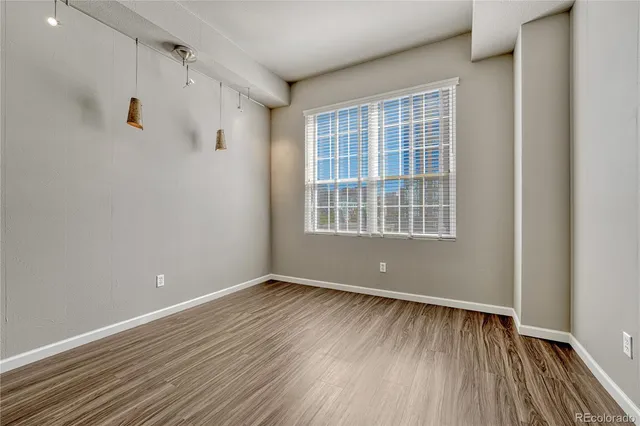 a view of a hallway with wooden floor and closet