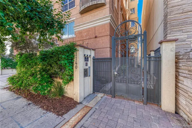 a view of a street with potted plants