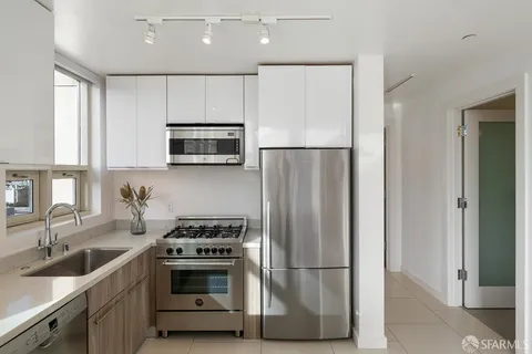 a kitchen with stainless steel appliances a refrigerator sink and microwave