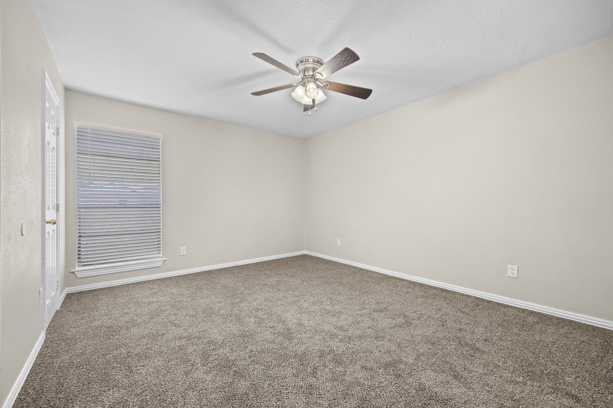 9616 Long Point Road, Unit 54 Houston, TX 77055 - Photo 12 of 18 an empty room with windows and fan