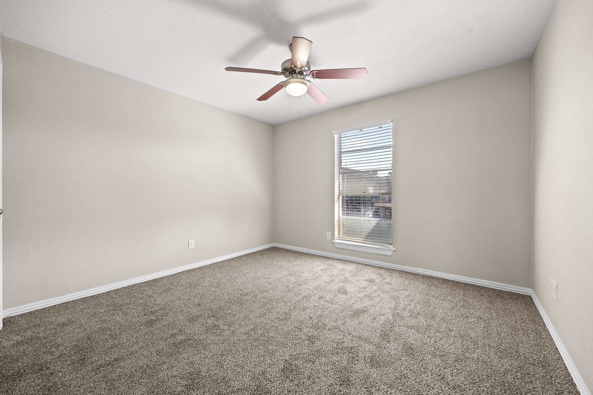9616 Long Point Road, Unit 54 Houston, TX 77055 - Photo 14 of 18 an empty room with a ceiling fan and window