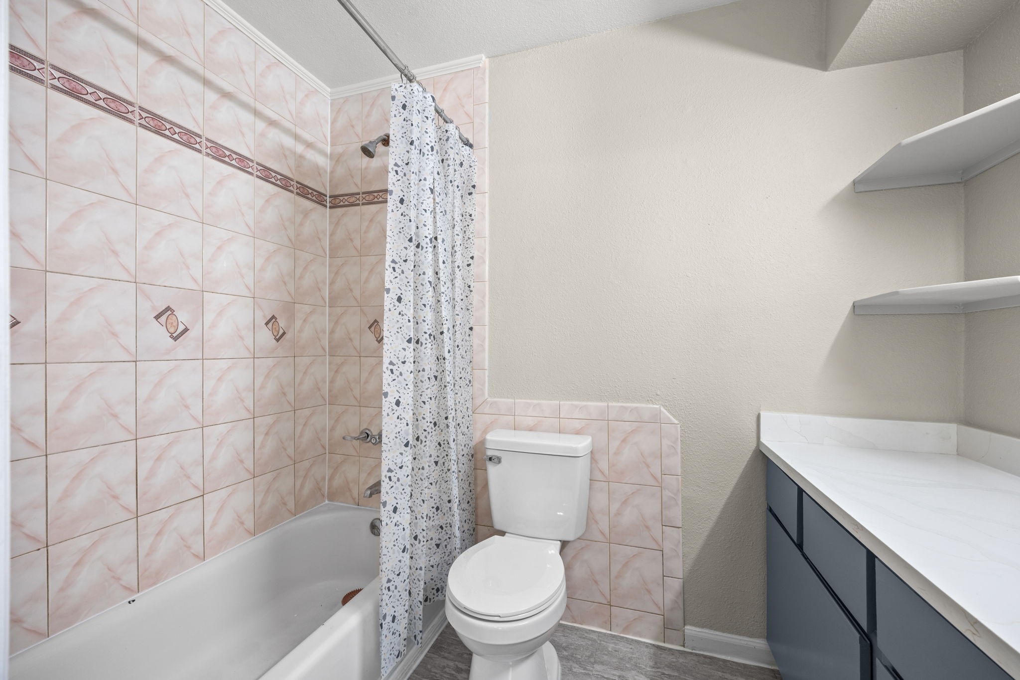 9616 Long Point Road, Unit 54 Houston, TX 77055 - Photo 16 of 18 a white toilet sitting next to a bath tub and a shower