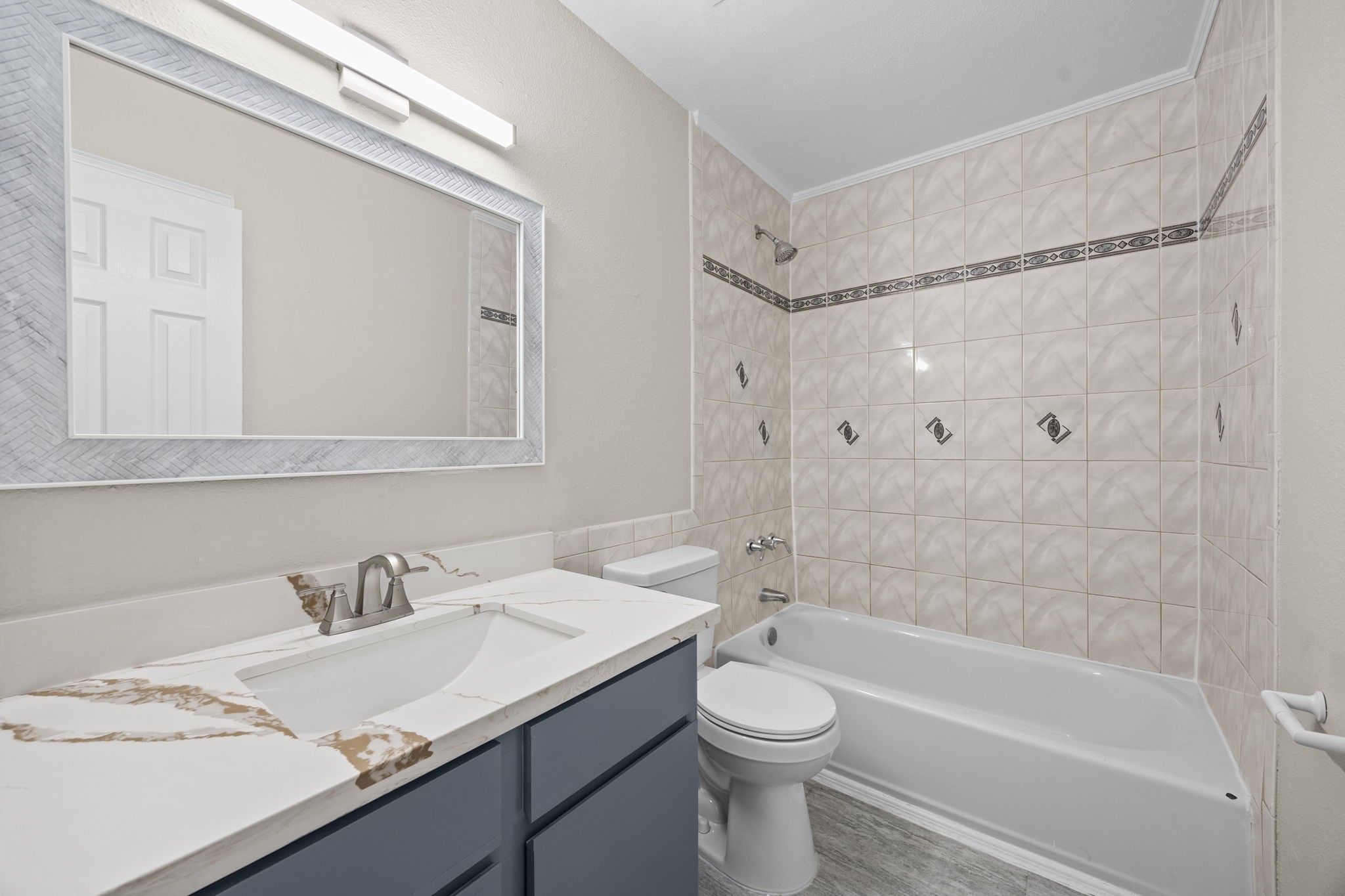 9616 Long Point Road, Unit 54 Houston, TX 77055 - Photo 17 of 18 a bathroom with a granite countertop sink toilet and shower