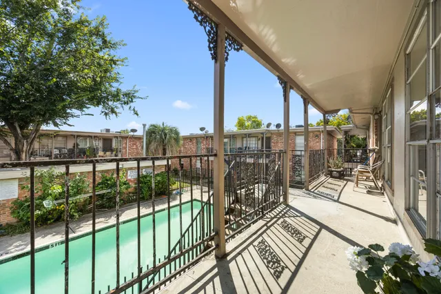 a view of a balcony with wooden floor