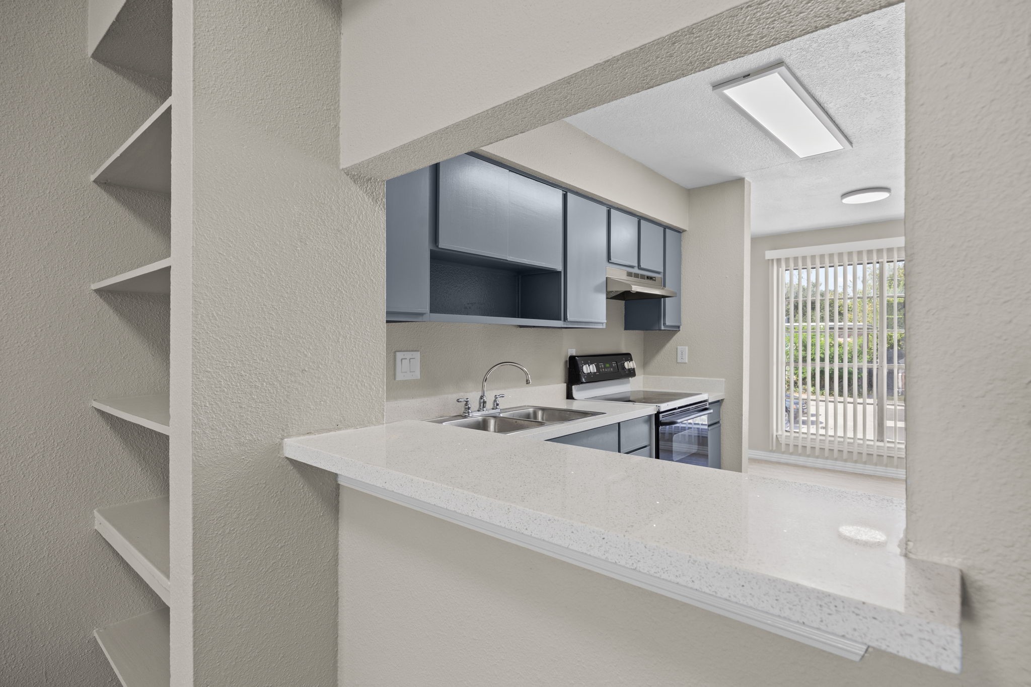 9616 Long Point Road, Unit 54 Houston, TX 77055 - Photo 8 of 18 a kitchen with a sink cabinets and a window