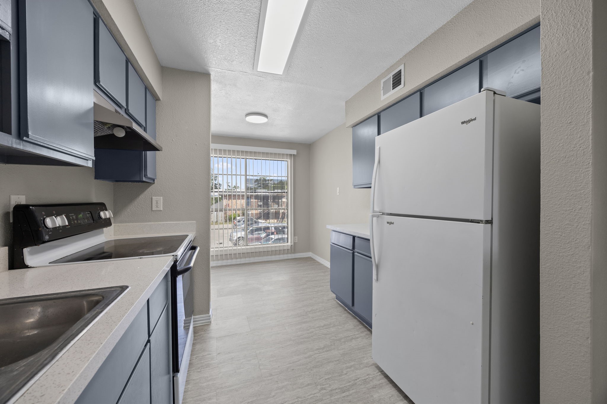 9616 Long Point Road, Unit 54 Houston, TX 77055 - Photo 10 of 18 a kitchen with a refrigerator a stove and a sink