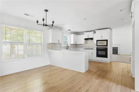 a view of a kitchen with wooden floor