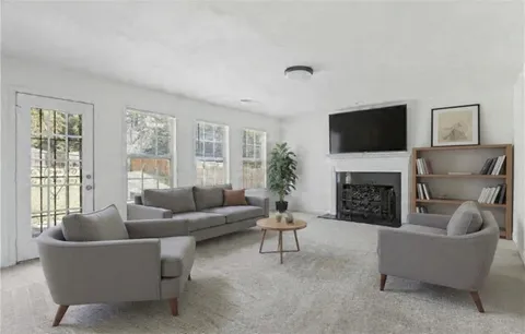 a living room with furniture a fireplace and a flat screen tv