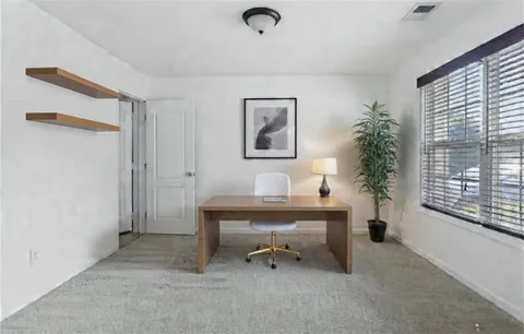 a view of workspace with furniture and a window