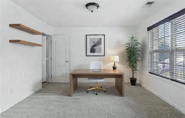 a view of workspace with furniture and a window