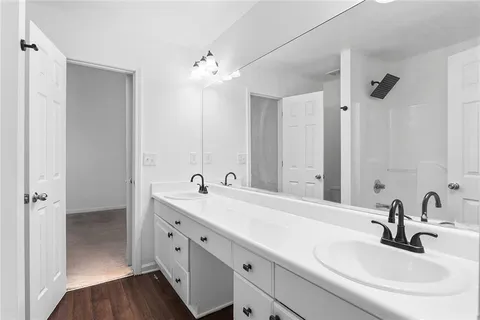 a bathroom with a double vanity sink and mirror
