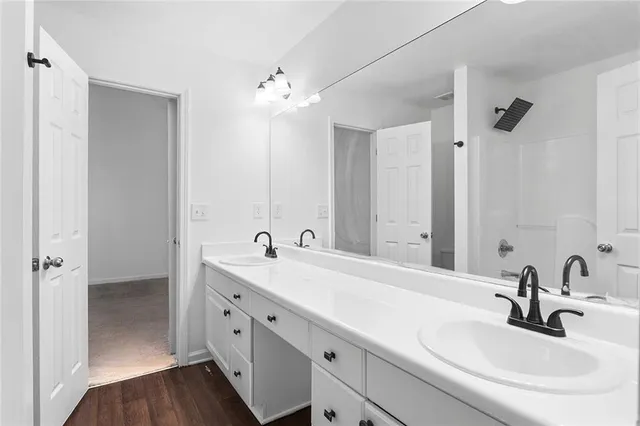 a bathroom with a double vanity sink and mirror