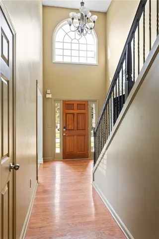 a view of an entryway wooden floor and a living room