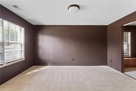 a room with a bed and windows