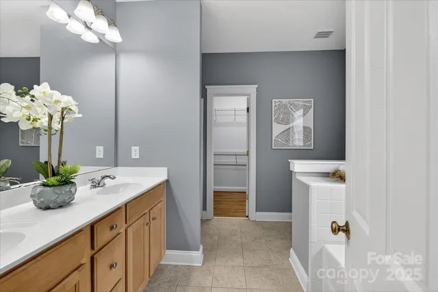 a bathroom with a sink a double vanity and a mirror