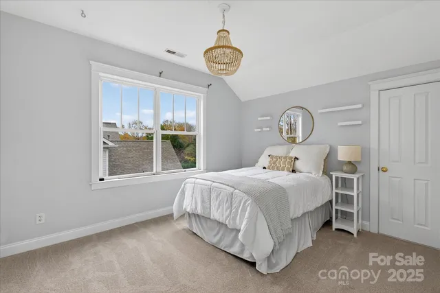 a bedroom with a bed a window and closet