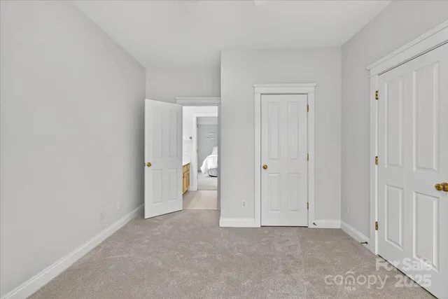 a view of an empty room and closet area