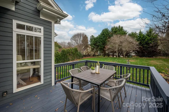 a view of balcony with wooden floor and outdoor seating