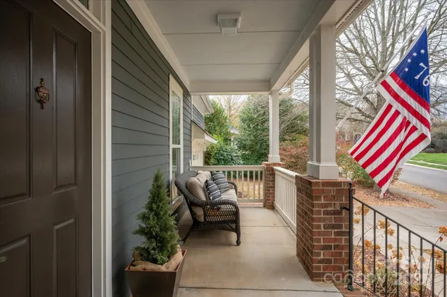 a balcony with chairs and wooden floor