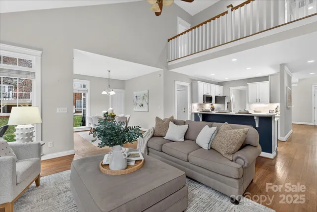 a living room with furniture and kitchen view