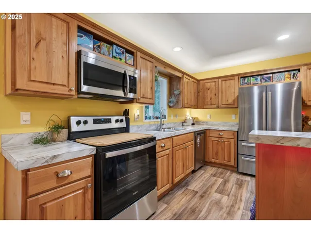 a living room with stainless steel appliances kitchen island granite countertop furniture and a kitchen view