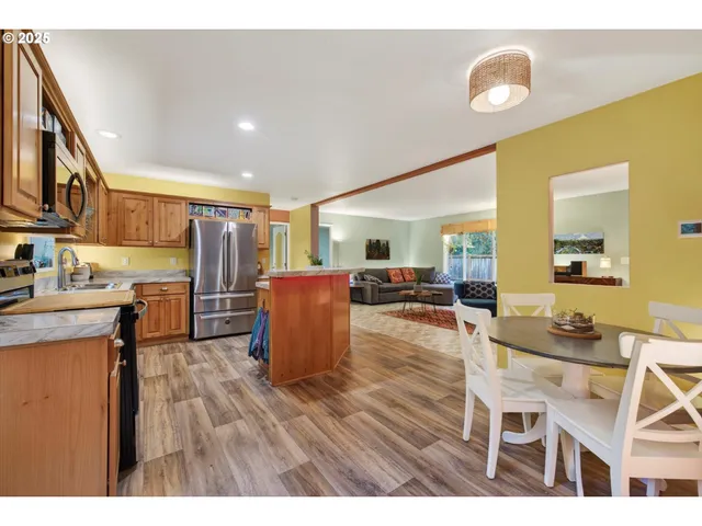 a kitchen with stainless steel appliances granite countertop a refrigerator and a sink