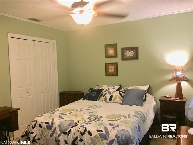 5925 Dixie Lane Mobile, AL 36693 - Photo 7 of 19 Bedroom featuring ceiling fan, ornamental molding, and a closet