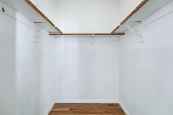 a bathroom with a granite countertop toilet sink and mirror