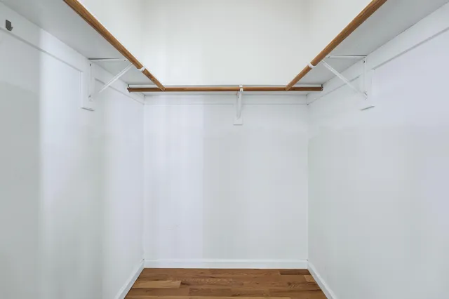a bathroom with a granite countertop toilet sink and mirror