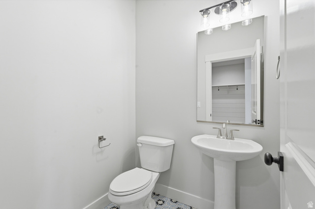 2970 North Mahogany Vly Road Logan, UT 84341 - Photo 32 of 39 Half bath with toilet and tile patterned flooring