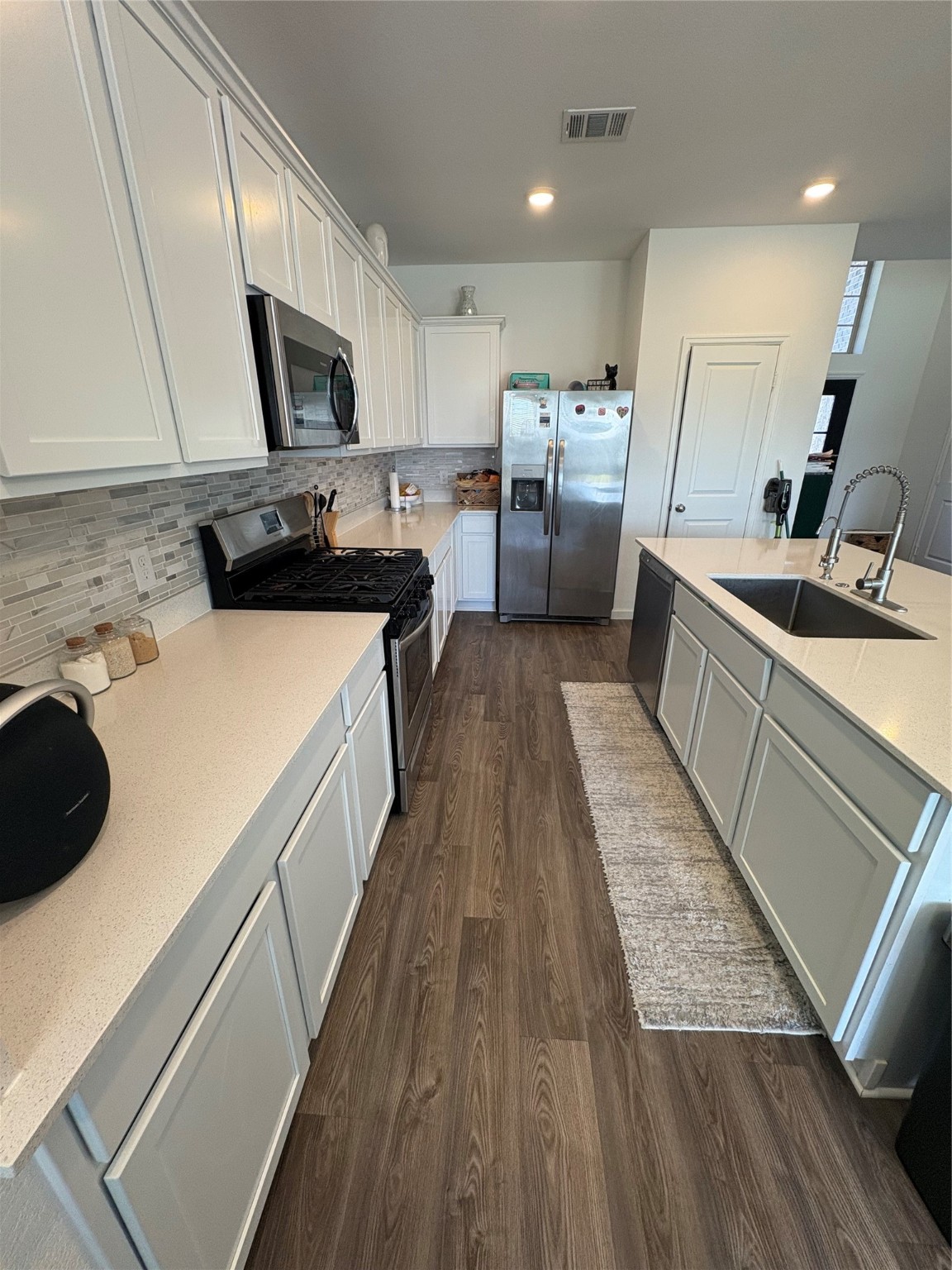 3703 Windy Brook Road Rosenberg, TX 77469 - Photo 7 of 22 a kitchen with a sink a counter top space stainless steel appliances and cabinets