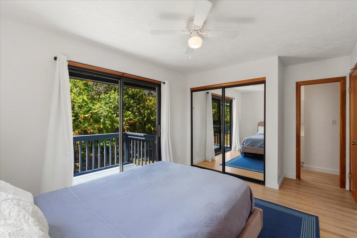 2130 Kauhikoa Road, Unit A Haiku, HI 96708 - Photo 20 of 43 a bedroom with a bed and a large window