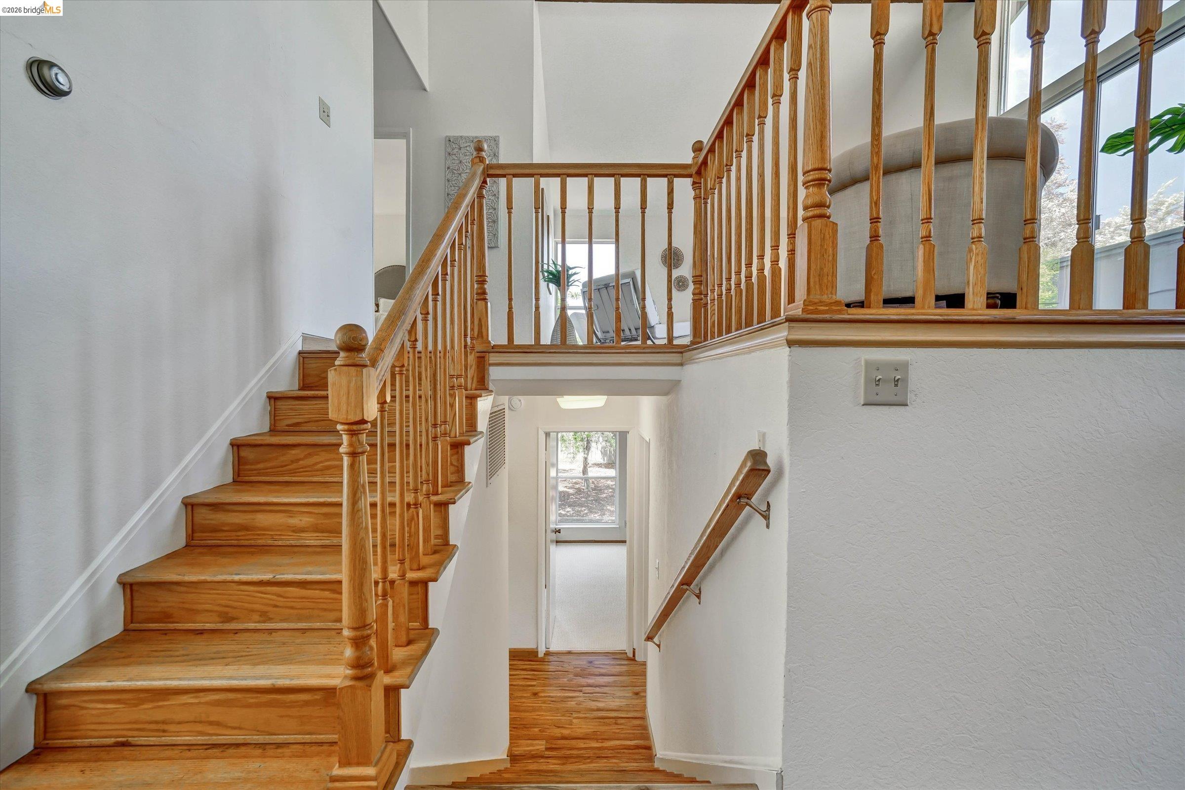 2826 Wright Avenue Pinole, CA 94564 - Photo 22 of 70 Hardwood staircase featuring a natural wood finish, matching balusters, and a substantial handrail