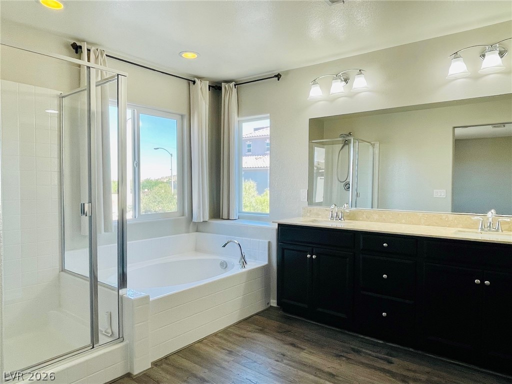 9921 Sable Point Street Las Vegas, NV 89178 - Photo 20 of 43 A spacious vanity and soaking tub highlight this beautifully designed primary bathroom.
