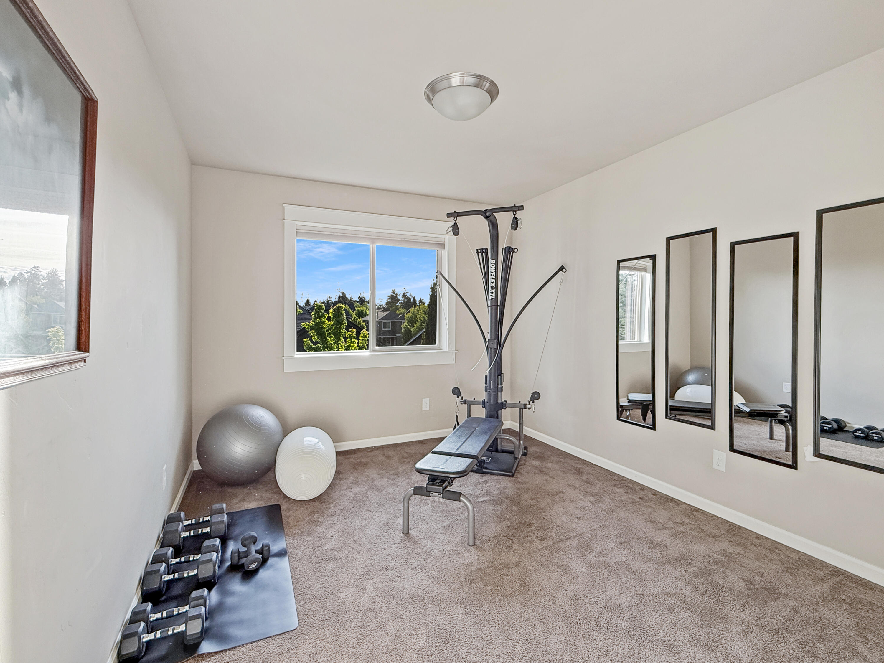 61072 Manhae Loop Bend, OR 97702 - Photo 37 of 63 a room with gym equipment and a large window