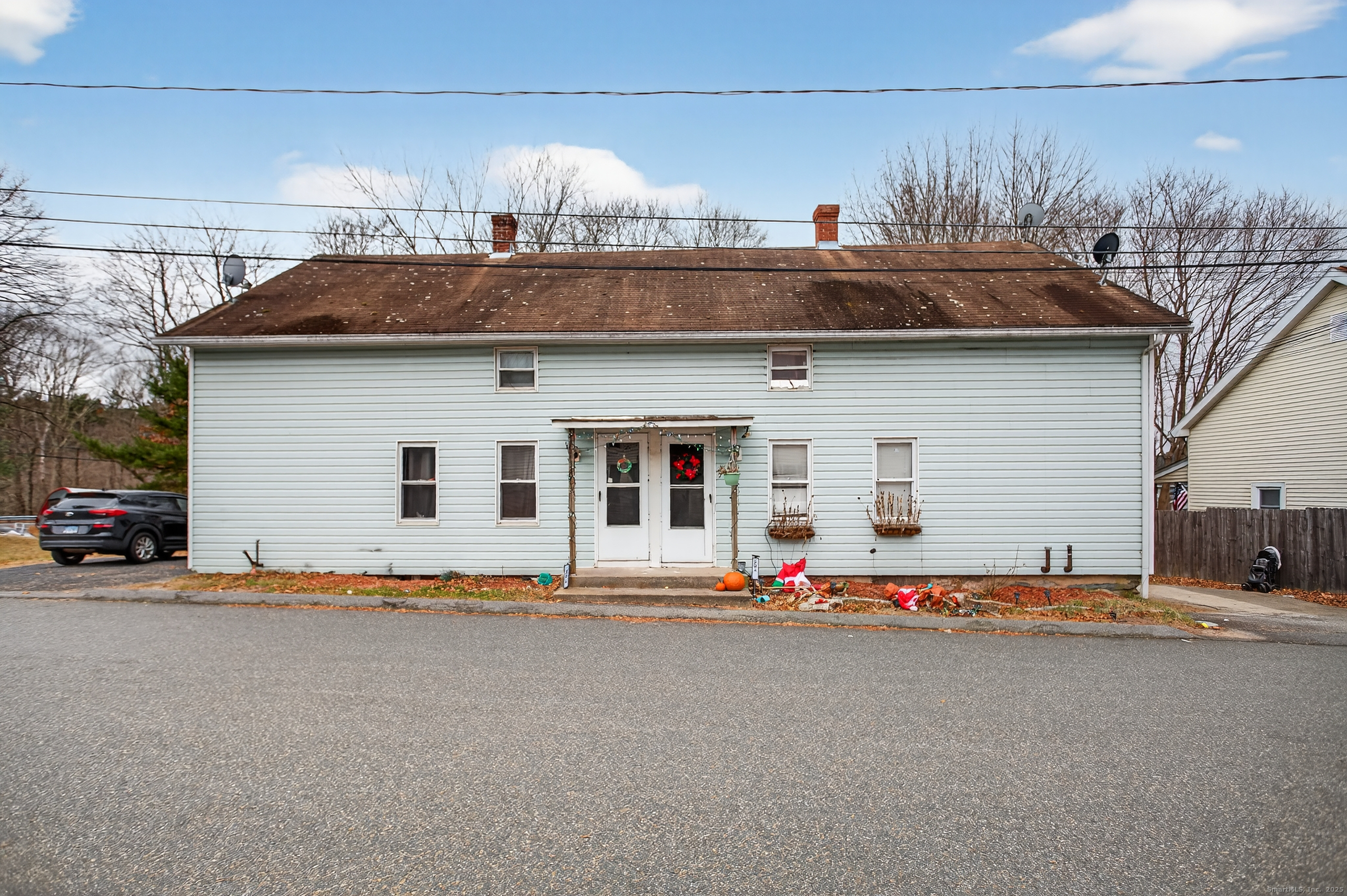 a front view of a house with a road
