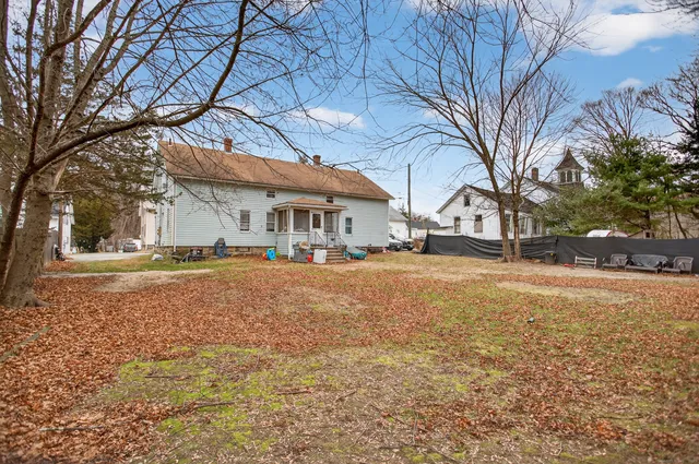 a house with yard and large trees