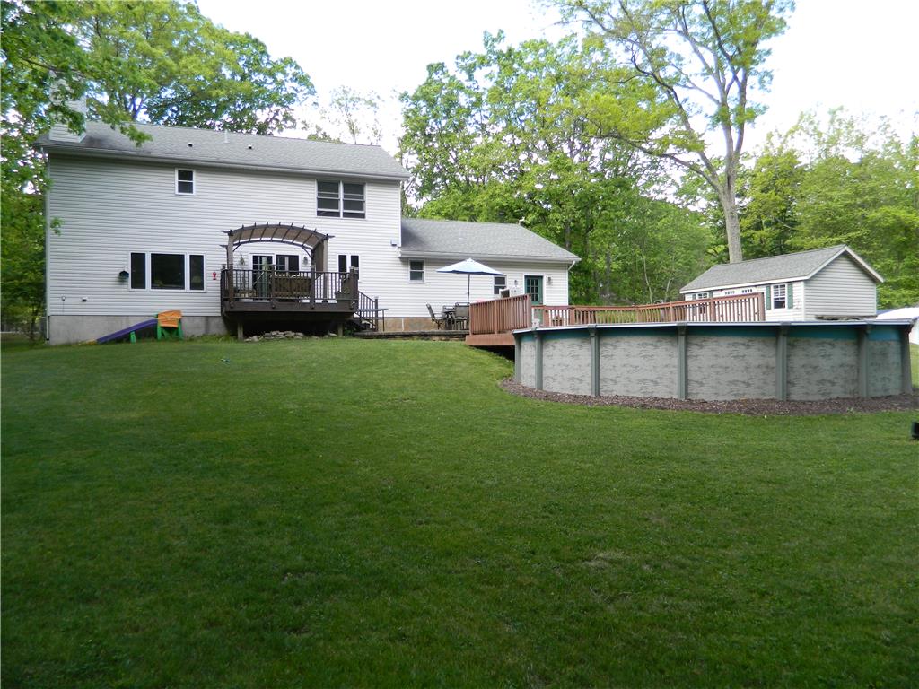 328 Pin Oak Road Stroudsburg, PA 18360 - Photo 6 of 37 An inviting backyard oasis offers a large deck, spacious lawn, and refreshing above-ground pool.