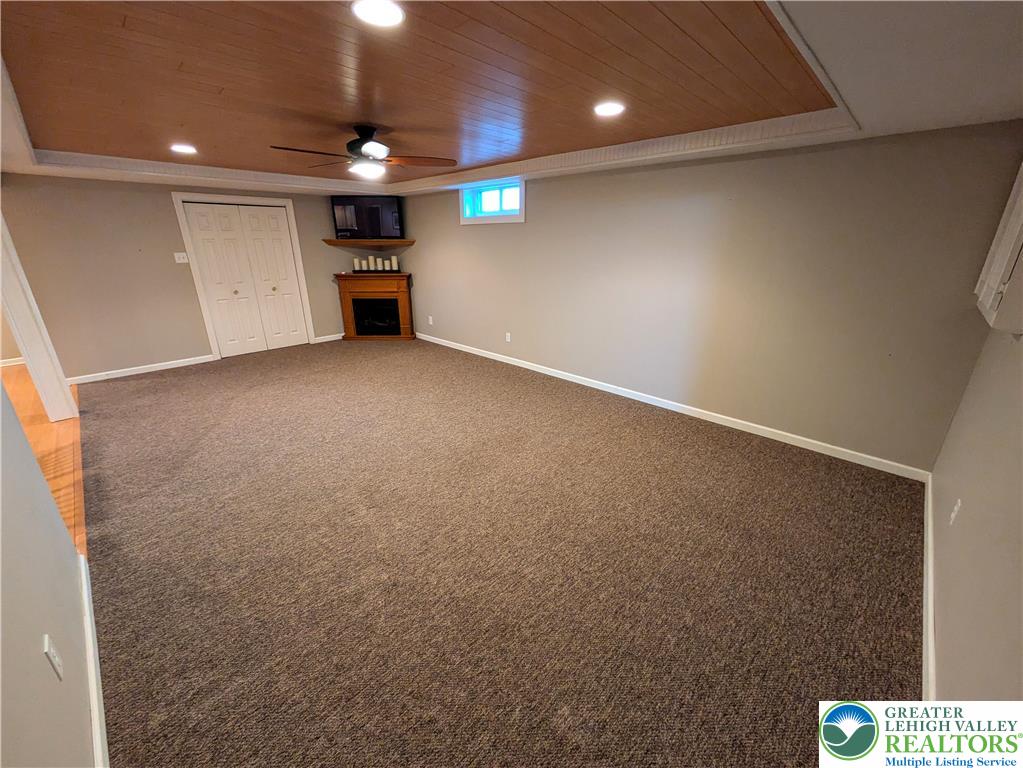 3285 Cherryville Road Northampton, PA 18067 - Photo 36 of 51 A spacious carpeted recreation room features a wood-paneled ceiling inlay and a corner gas fireplace.