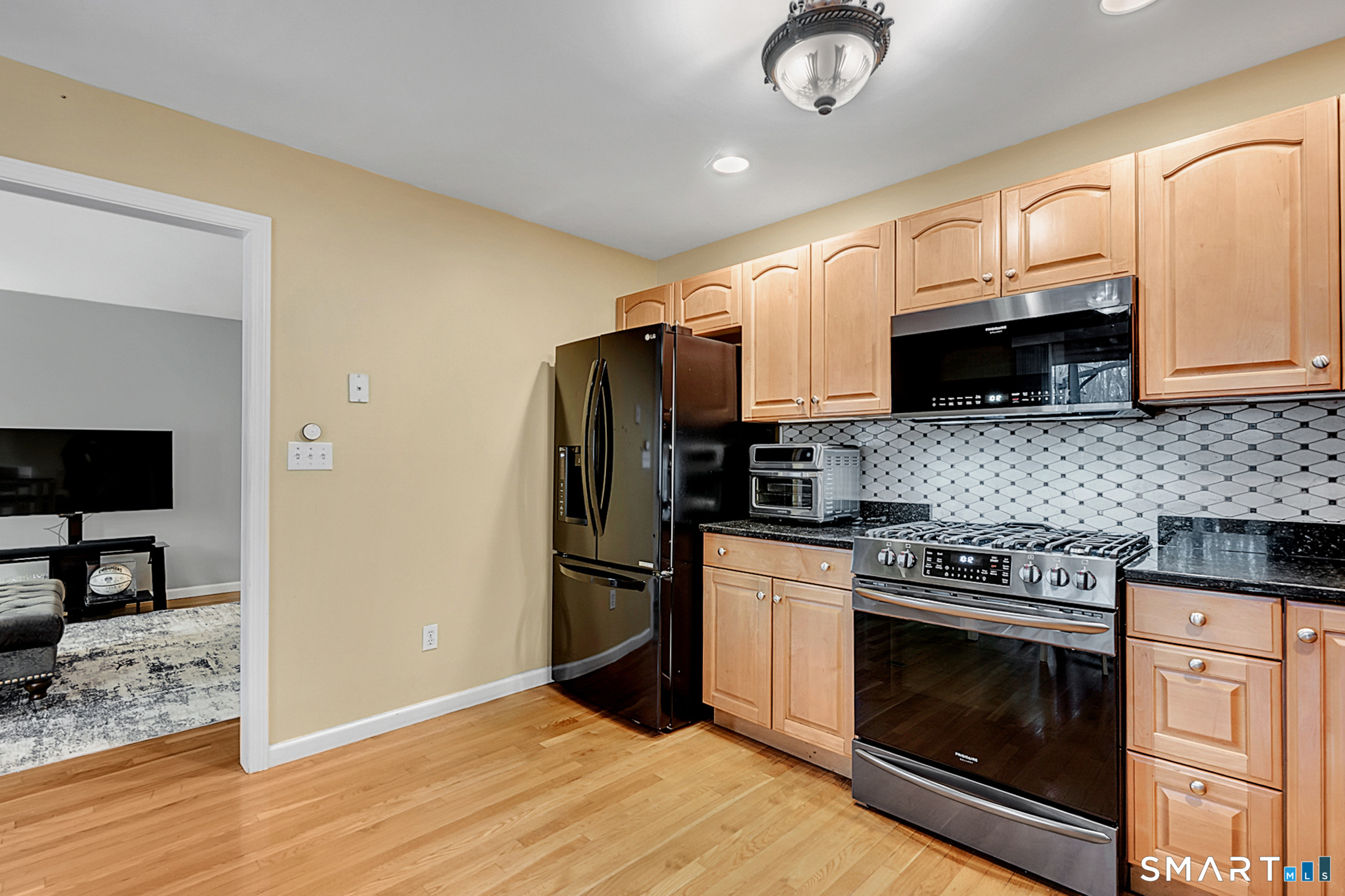 30 Silver Sands Road, Unit C9 East Haven, CT 06512 - Photo 4 of 36 a kitchen with granite countertop a refrigerator stove and microwave