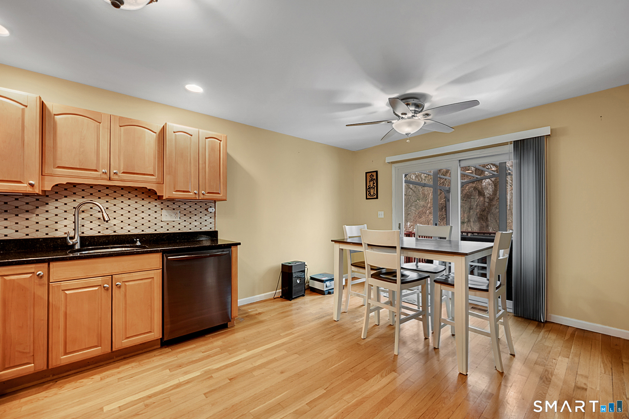 30 Silver Sands Road, Unit C9 East Haven, CT 06512 - Photo 5 of 36 a kitchen with stainless steel appliances granite countertop a stove top oven a sink dishwasher a dining table and chairs with wooden floor