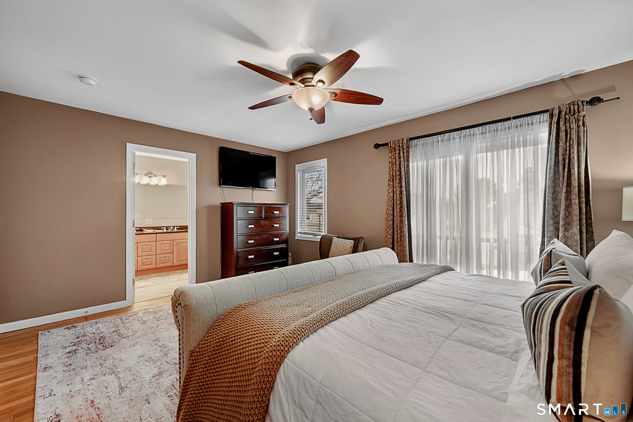 30 Silver Sands Road, Unit C9 East Haven, CT 06512 - Photo 10 of 36 a bedroom with a large bed and a flat tv screen