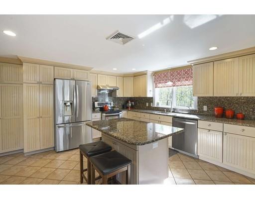 20 Manning Street Lexington, MA 02421 - Photo 9 of 21 a kitchen with stainless steel appliances granite countertop a sink stove and refrigerator